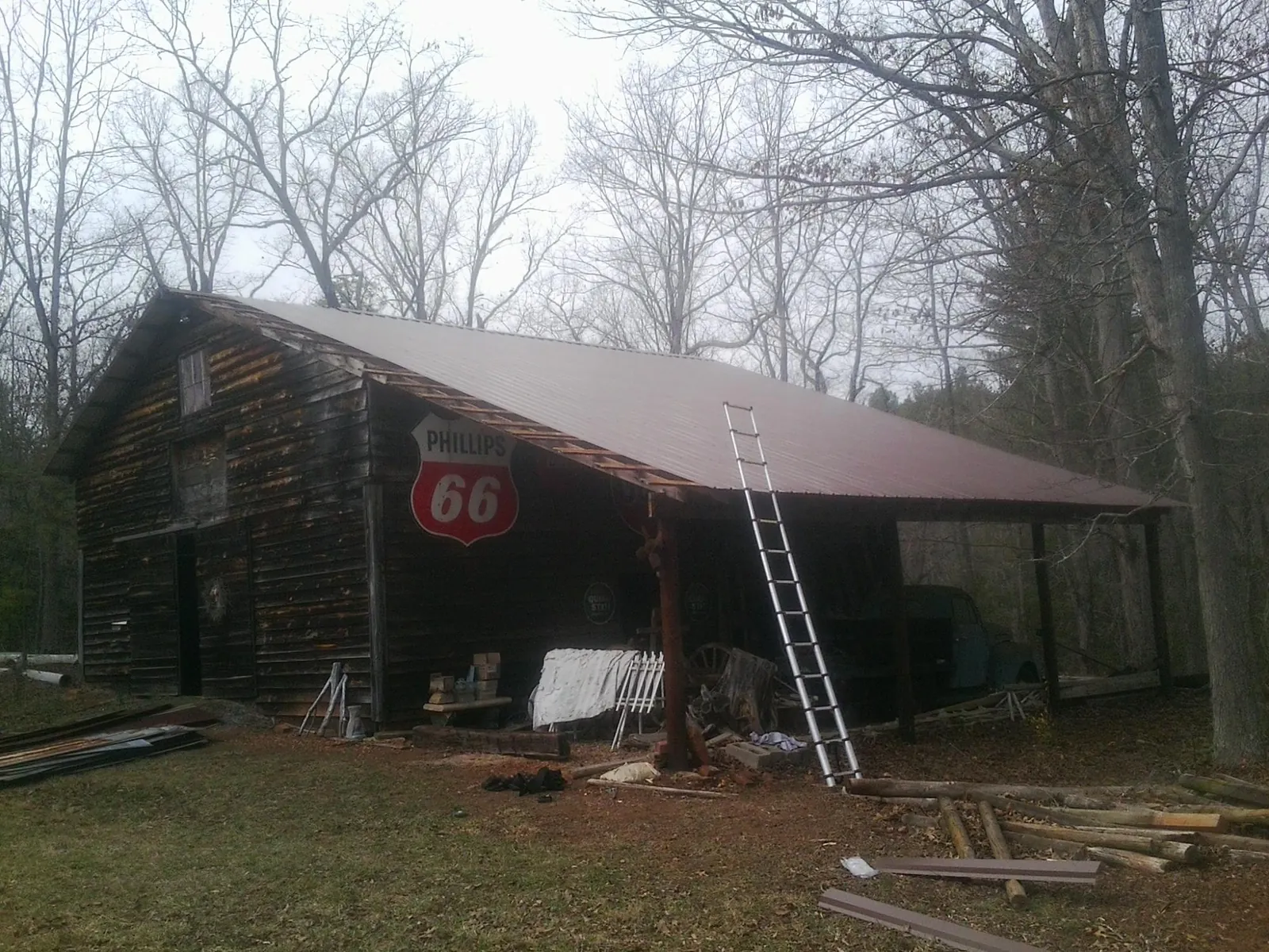 New metal roof on an open sided timber barn with a vintage sign in Lackawaxen